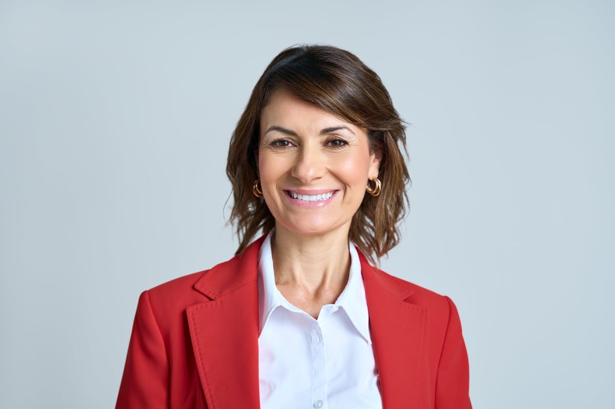 Headshot close up isolated portrait of latin hispanic confident mature good looking middle age leader, ceo female businesswoman on background. Gorgeous beautiful business woman smiling at camera.